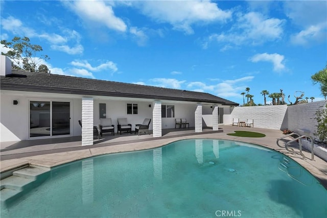 2480 N Aurora Dr, Palm Springs, CA 92262 - back of house featuring a patio area, outdoor lounge area, and stucco siding