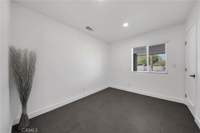 spare room featuring baseboards, recessed lighting, and visible vents