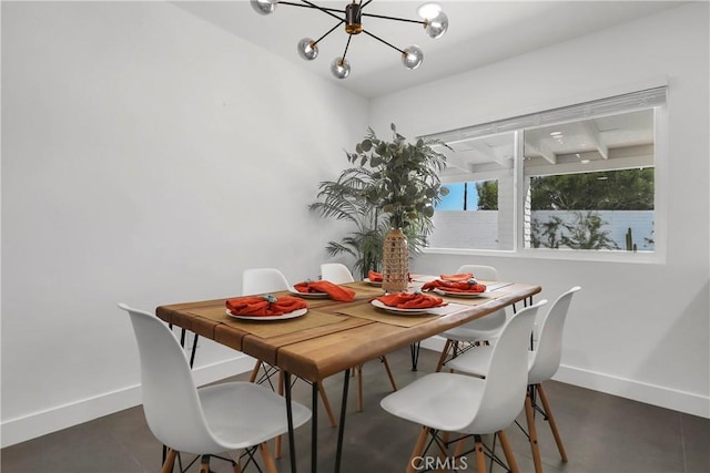 dining area with an inviting chandelier and baseboards