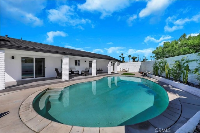 view of swimming pool with a patio, a fenced in pool, and a fenced backyard