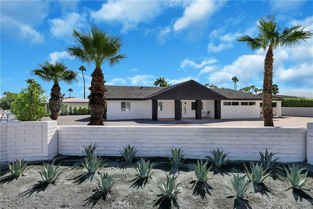 single story home featuring a garage and fence private yard