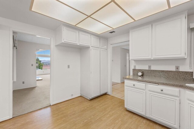 1109 Calle Del Baston, San Marcos, CA 92078 - kitchen featuring white cabinets and light wood-style flooring