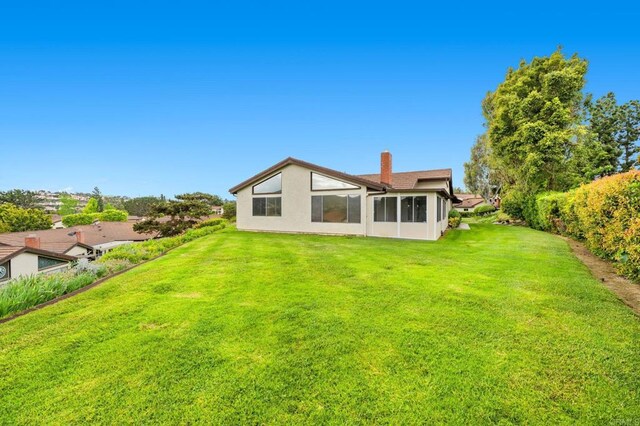 1109 Calle Del Baston, San Marcos, CA 92078 - rear view of property featuring a chimney, a lawn, and stucco siding