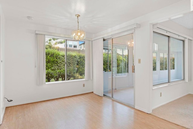 1109 Calle Del Baston, San Marcos, CA 92078 - unfurnished room featuring a chandelier, wood finished floors, and a smoke detector