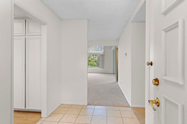 1109 Calle Del Baston, San Marcos, CA 92078 - hall featuring light carpet, light tile patterned flooring, and a textured ceiling