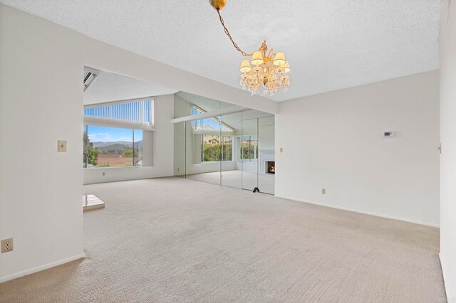 1109 Calle Del Baston, San Marcos, CA 92078 - empty room featuring a chandelier, carpet, and a textured ceiling