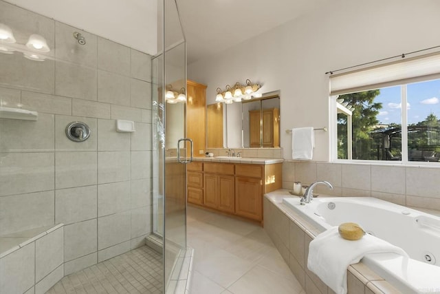 bathroom with vanity, tile patterned floors, a stall shower, and a tub with jets