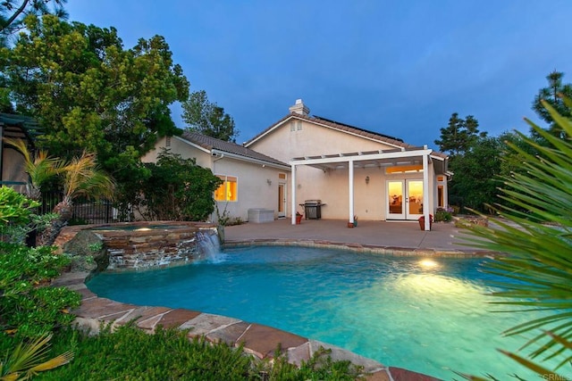 view of swimming pool with an in ground hot tub, french doors, a patio area, a fenced in pool, and a pergola