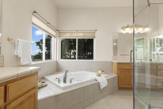 full bathroom featuring vanity, tile patterned flooring, a garden tub, and a stall shower