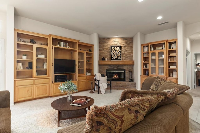living room featuring visible vents, a fireplace, recessed lighting, and light colored carpet