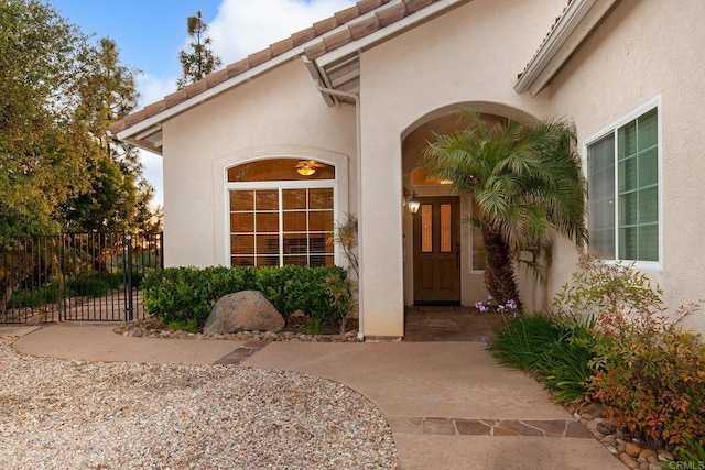 property entrance with fence and stucco siding