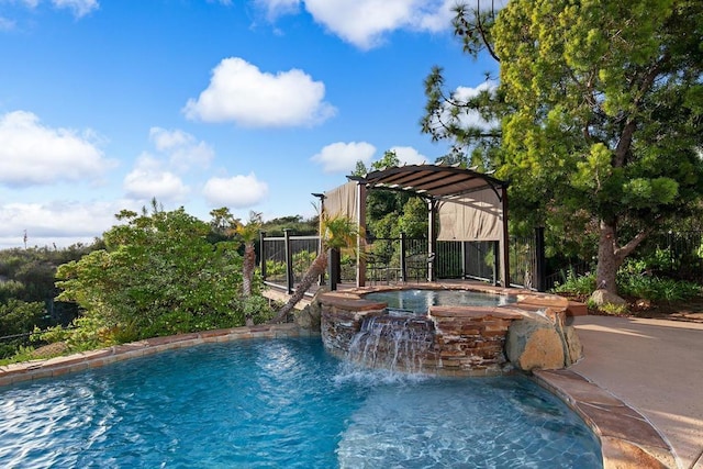 view of pool with fence and a pool with connected hot tub