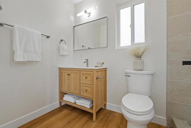 5061 Canosa Ave, San Diego, CA 92117 - bathroom with vanity, wood finished floors, toilet, baseboards, and tiled shower