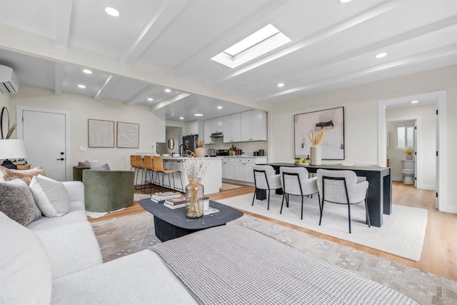5061 Canosa Ave, San Diego, CA 92117 - living room featuring recessed lighting, light wood-style flooring, a wall unit AC, and beam ceiling