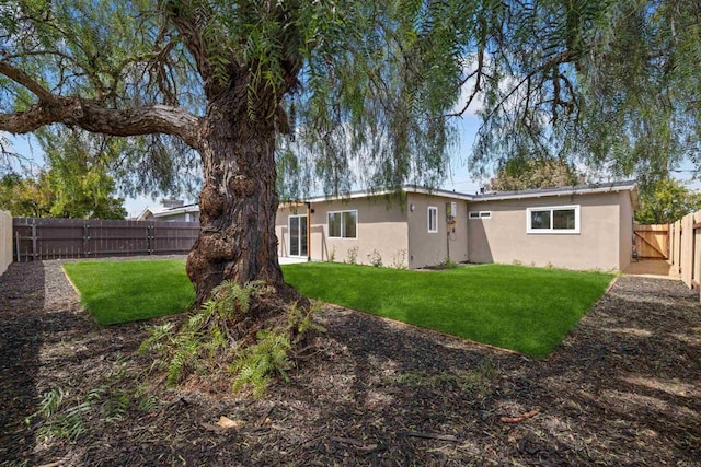 5061 Canosa Ave, San Diego, CA 92117 - rear view of house with a yard, a fenced backyard, and stucco siding