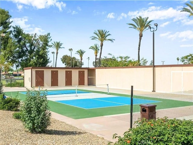 view of tennis court featuring fence