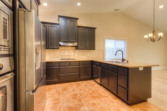 kitchen with a sink, stainless steel appliances, a peninsula, backsplash, and vaulted ceiling