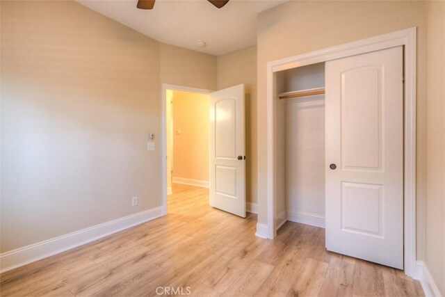 unfurnished bedroom featuring baseboards, a closet, and light wood finished floors
