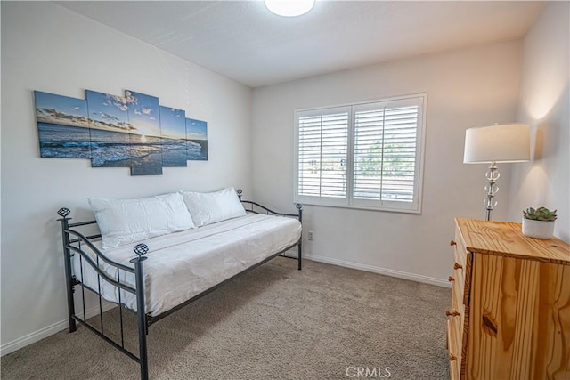 carpeted bedroom featuring baseboards