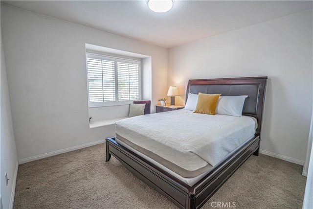 bedroom featuring baseboards and carpet flooring