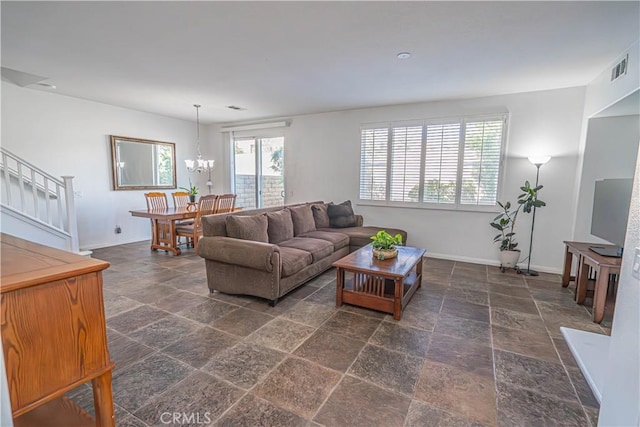 living room featuring a healthy amount of sunlight, baseboards, and stone tile floors