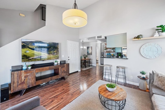 4658 Ohio St, San Diego, CA 92116 - living room featuring wood finished floors, a high ceiling, baseboards, and a chandelier