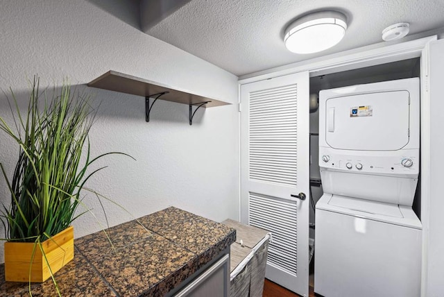 4658 Ohio St, San Diego, CA 92116 - laundry area featuring stacked washer / dryer, a textured ceiling, and a textured wall