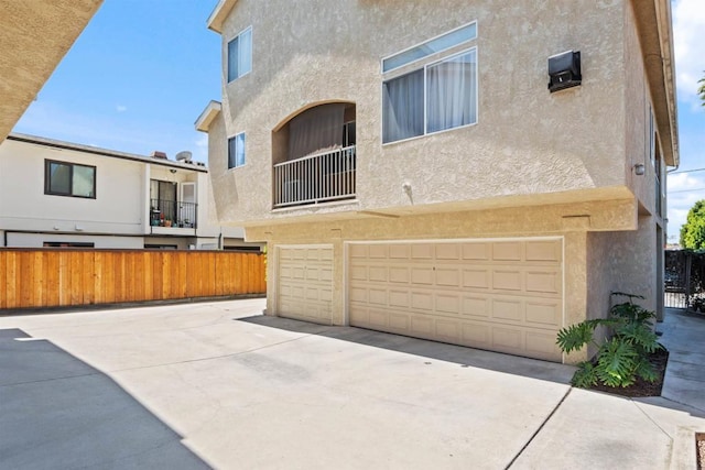 4658 Ohio St, San Diego, CA 92116 - rear view of house with stucco siding, a garage, and concrete driveway