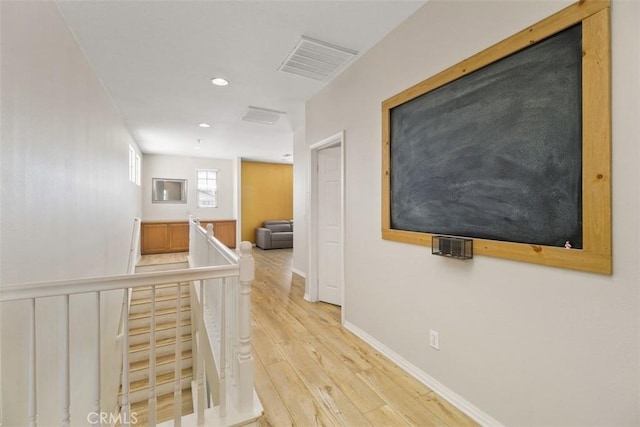 34787 Grotto Hills Dr, Winchester, CA 92596 - hallway with visible vents, baseboards, an upstairs landing, recessed lighting, and light wood-style flooring
