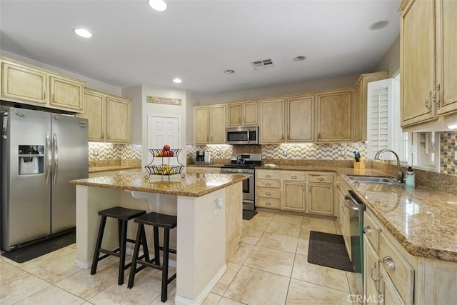 34787 Grotto Hills Dr, Winchester, CA 92596 - kitchen featuring a center island, a sink, appliances with stainless steel finishes, and light stone counters