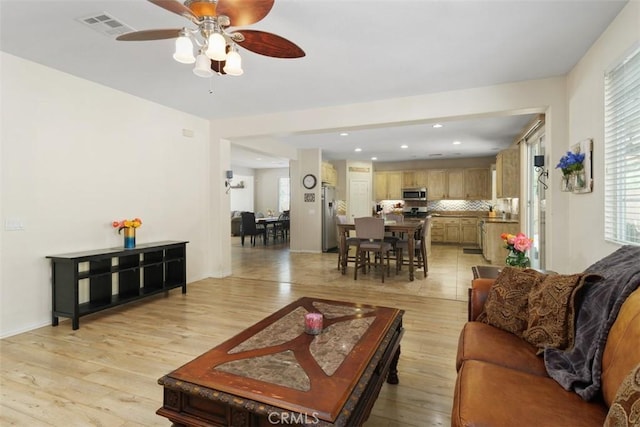 34787 Grotto Hills Dr, Winchester, CA 92596 - living room featuring ceiling fan, visible vents, a healthy amount of sunlight, and light wood-type flooring
