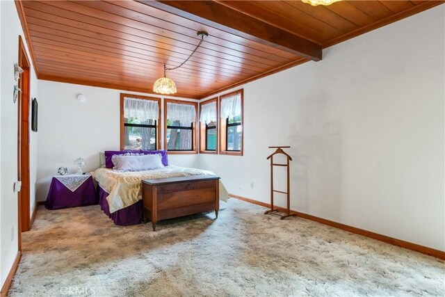 bedroom featuring baseboards, carpet flooring, wooden ceiling, and ornamental molding