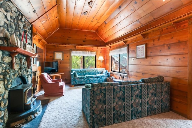 carpeted living area featuring wood ceiling, a wood stove, vaulted ceiling, and wood walls