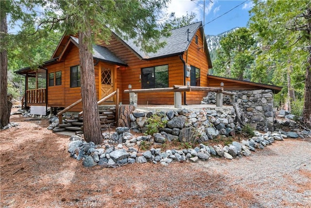 view of front of home featuring roof with shingles