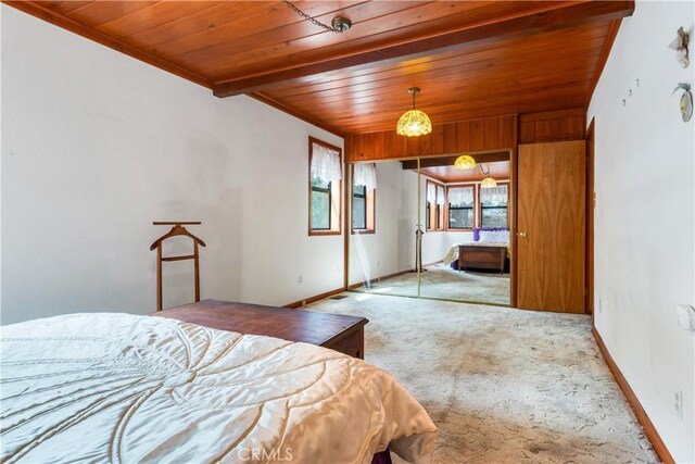 carpeted bedroom featuring baseboards and wooden ceiling