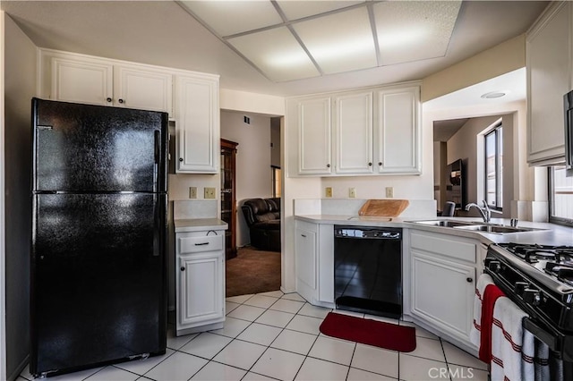 749 Cortez Dr, Hemet, CA 92545 - kitchen with white cabinets, light tile patterned flooring, a sink, light countertops, and black appliances