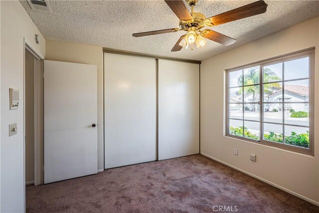749 Cortez Dr, Hemet, CA 92545 - unfurnished bedroom with carpet floors, a textured ceiling, visible vents, and a closet