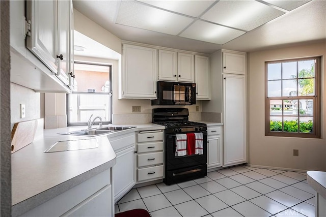 749 Cortez Dr, Hemet, CA 92545 - kitchen featuring a sink, light countertops, black appliances, light tile patterned flooring, and white cabinetry