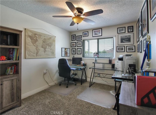 home office with baseboards, ceiling fan, carpet, and a textured ceiling