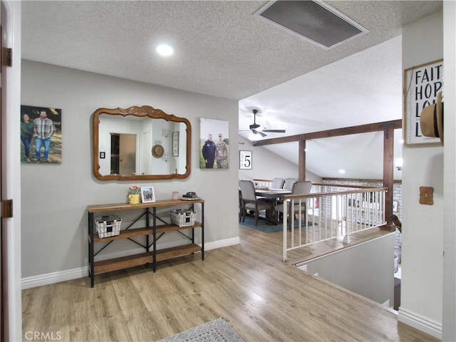 hallway with baseboards, recessed lighting, wood finished floors, and visible vents