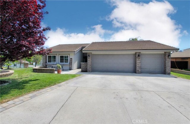 single story home featuring an attached garage, concrete driveway, a tile roof, and a front yard