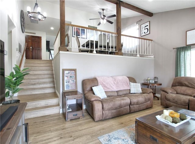 living area with beam ceiling, a ceiling fan, recessed lighting, wood finished floors, and stairway