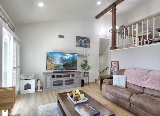 living room featuring recessed lighting, vaulted ceiling with beams, stairs, and visible vents