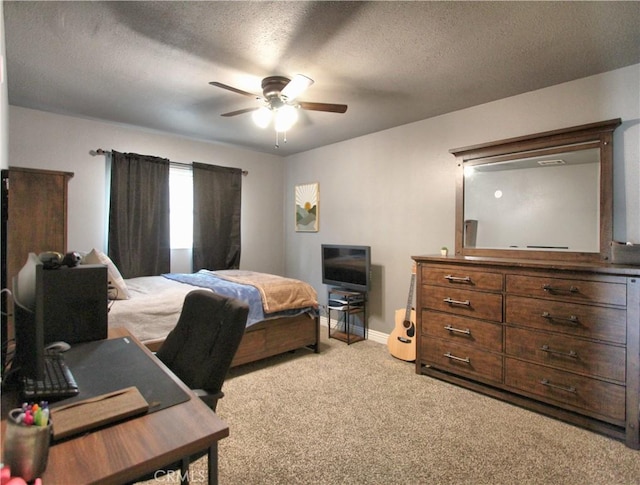 bedroom with baseboards, a textured ceiling, carpet, and ceiling fan