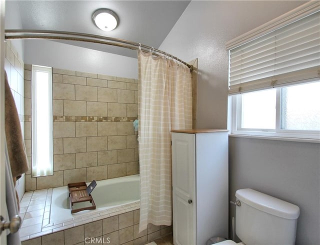 full bathroom with tiled shower / bath and toilet