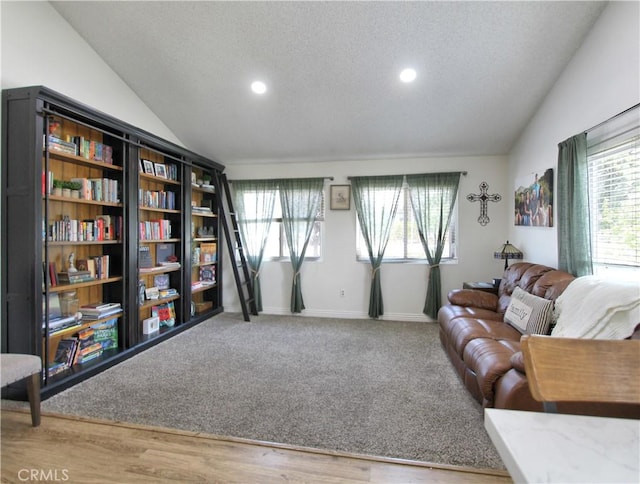 living room featuring plenty of natural light, vaulted ceiling, and recessed lighting