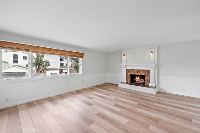 309 W Avenida Valencia, San Clemente, CA 92672 - unfurnished living room featuring a tile fireplace and light wood-style floors