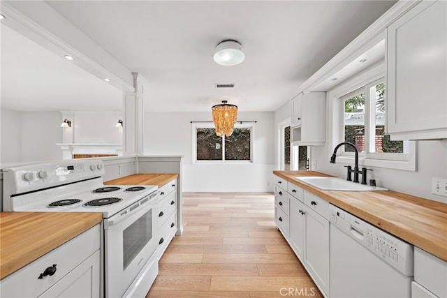 309 W Avenida Valencia, San Clemente, CA 92672 - kitchen with visible vents, butcher block counters, white appliances, light wood-style floors, and a sink
