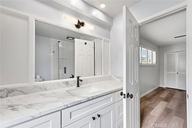 309 W Avenida Valencia, San Clemente, CA 92672 - full bath featuring a stall shower, wood finished floors, vanity, baseboards, and toilet