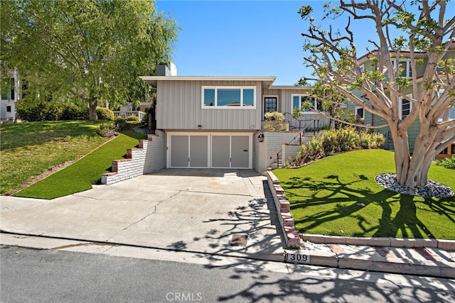 309 W Avenida Valencia, San Clemente, CA 92672 - view of front of property featuring an attached garage, driveway, a chimney, and a front yard